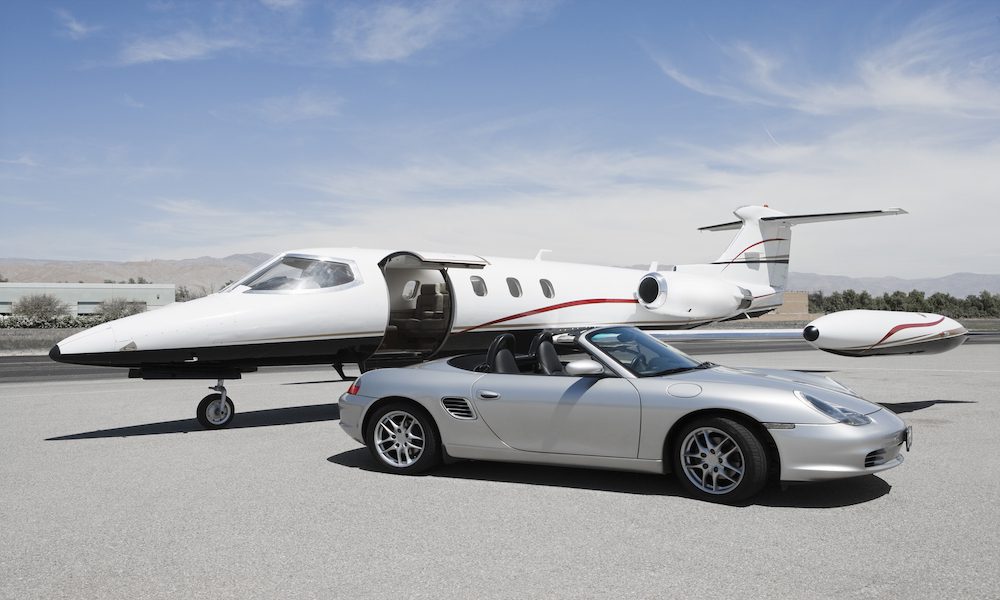 Luxury Asset Diversification blog-personal jet and porche sitting on tarmac.